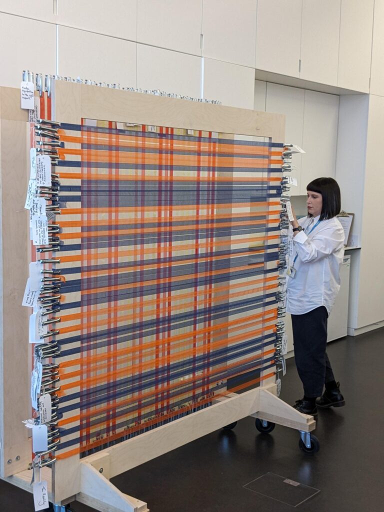 Local designer Linsey McIntosh with the finished warp and weft of magical tartan