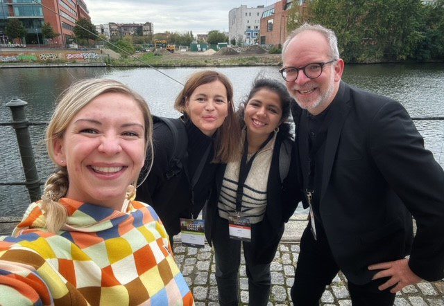 Katie Murrie in checked hoodie with other SDGC speakers